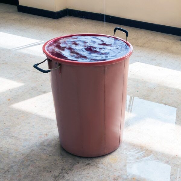 water leak bucket on floor
