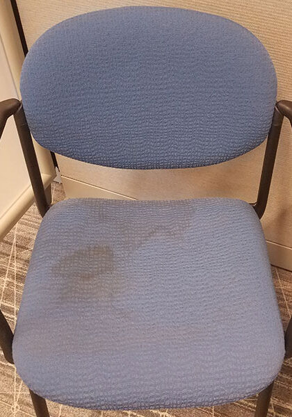 Office furniture restoration - photo of a stained guest chair.