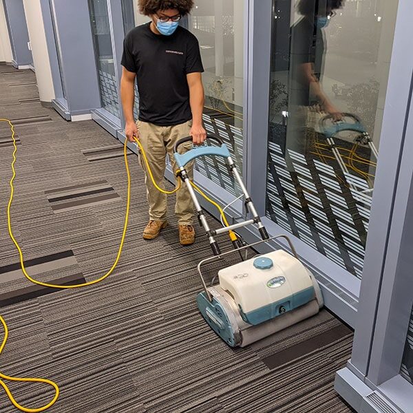team member cleaning carpet