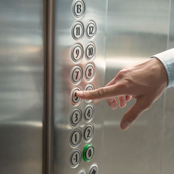hands pressing elevator button - Metal Polishing Service and Maintenance