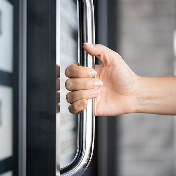 hand pulling metal door handle - Metal Polishing Service and Maintenance