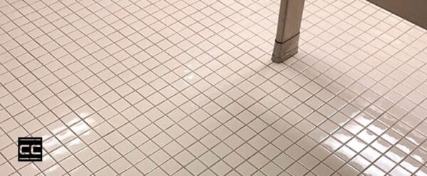 A cleaned and CareGuard protective coated bathroom tile floor