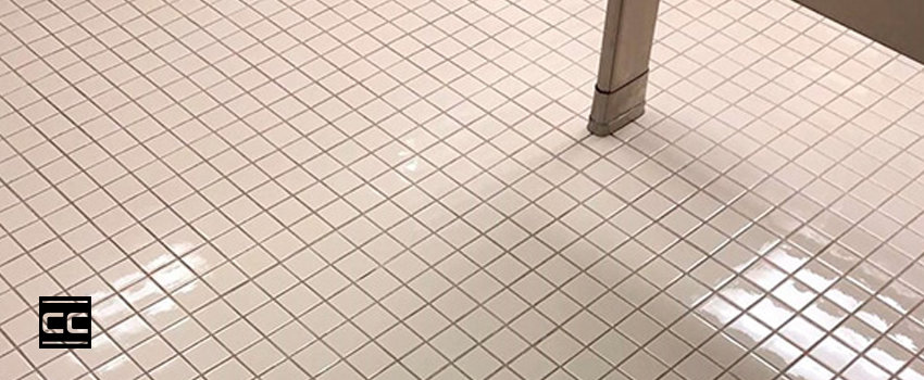 A cleaned and CareGuard protective coated bathroom tile floor