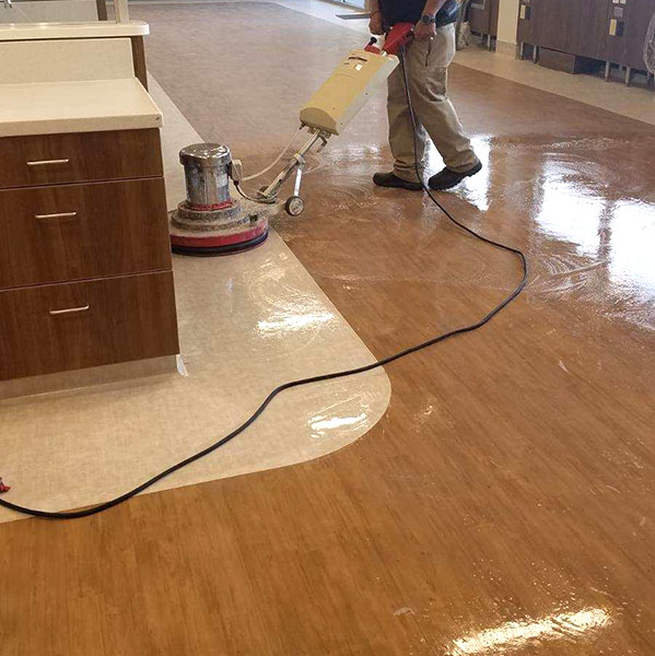 Deep cleaning scrub of LVT flooring prior to application of CareGuard protective coating.