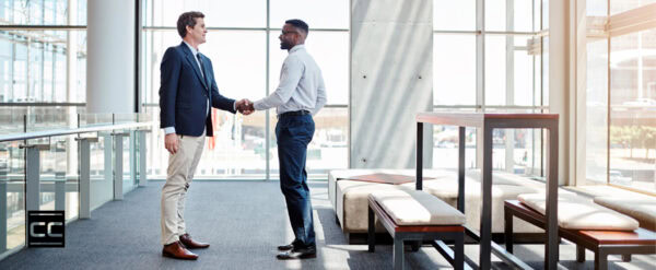 Facility manager and deep cleaning specialist shaking hands in lobby